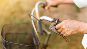 elderly hands holding bike handlebars