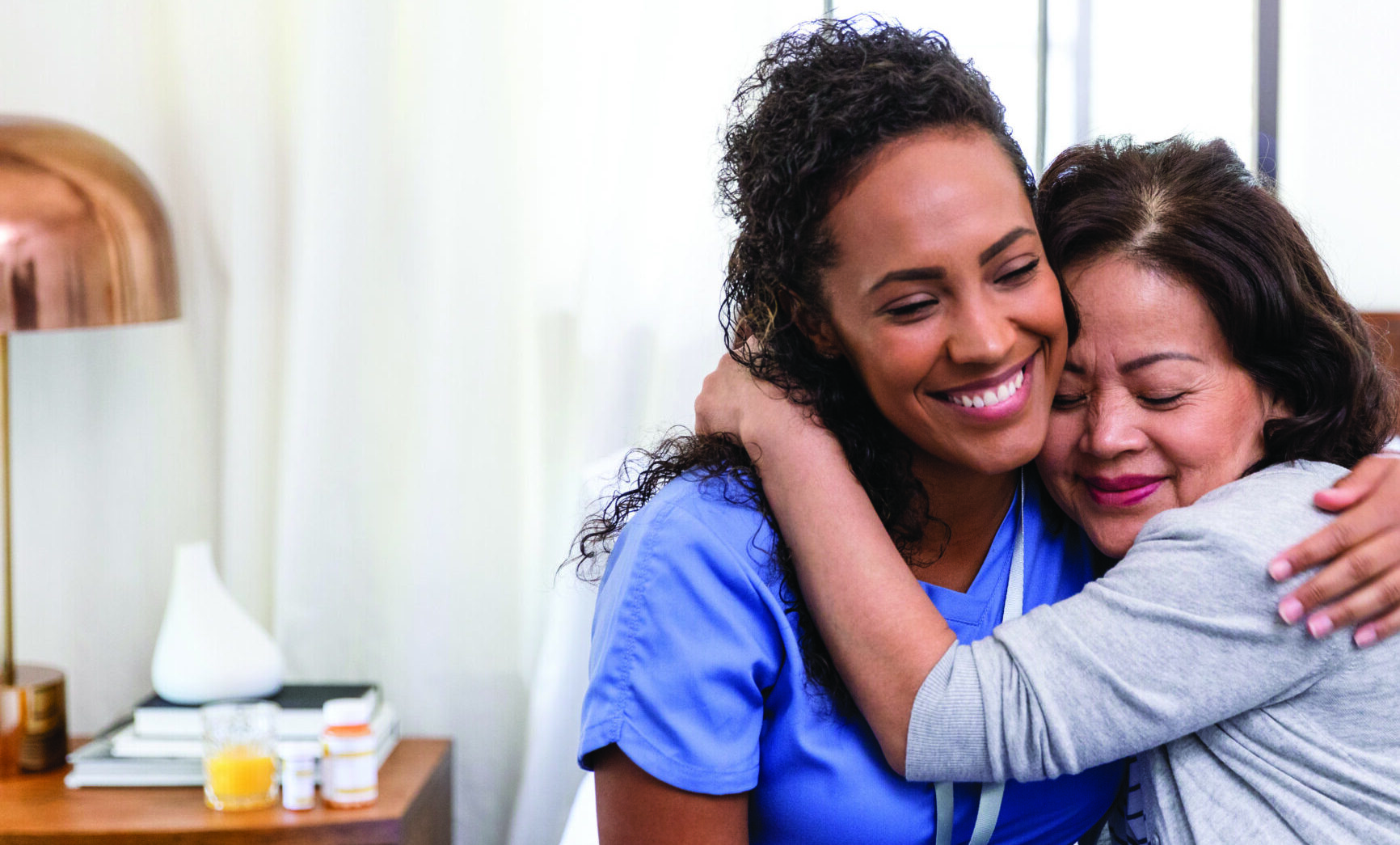 Senior patient happy to see her nurse - giving her a hug