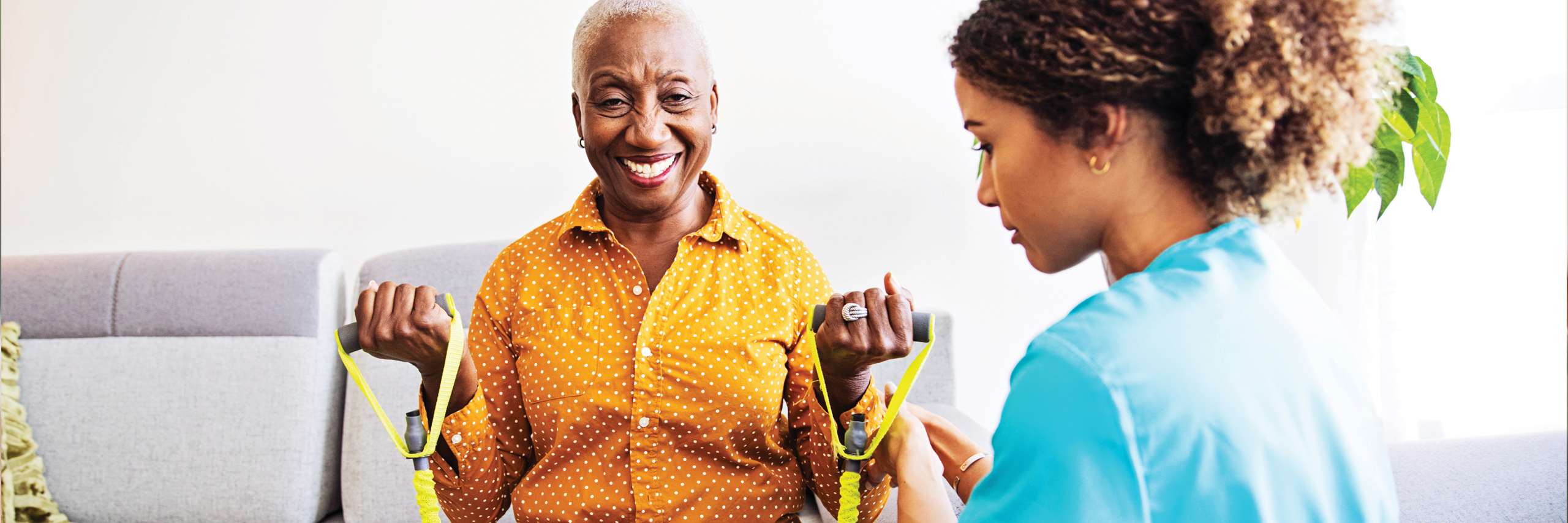 Image of an older Home Health patient working with a physical therapist. Smiling and being active